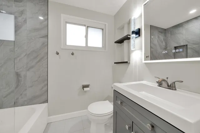 a bathroom with a sink toilet and shower