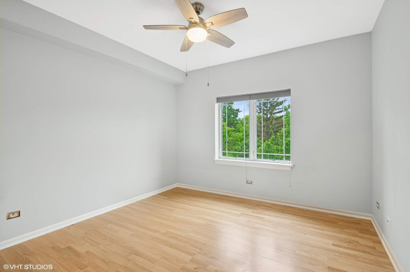 911 Busse Highway, Unit 302 Park Ridge, IL 60068 - Photo 11 of 17 an empty room with a window and a ceiling fan