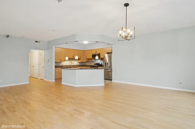 a view of a kitchen with a sink stainless steel appliances and cabinets