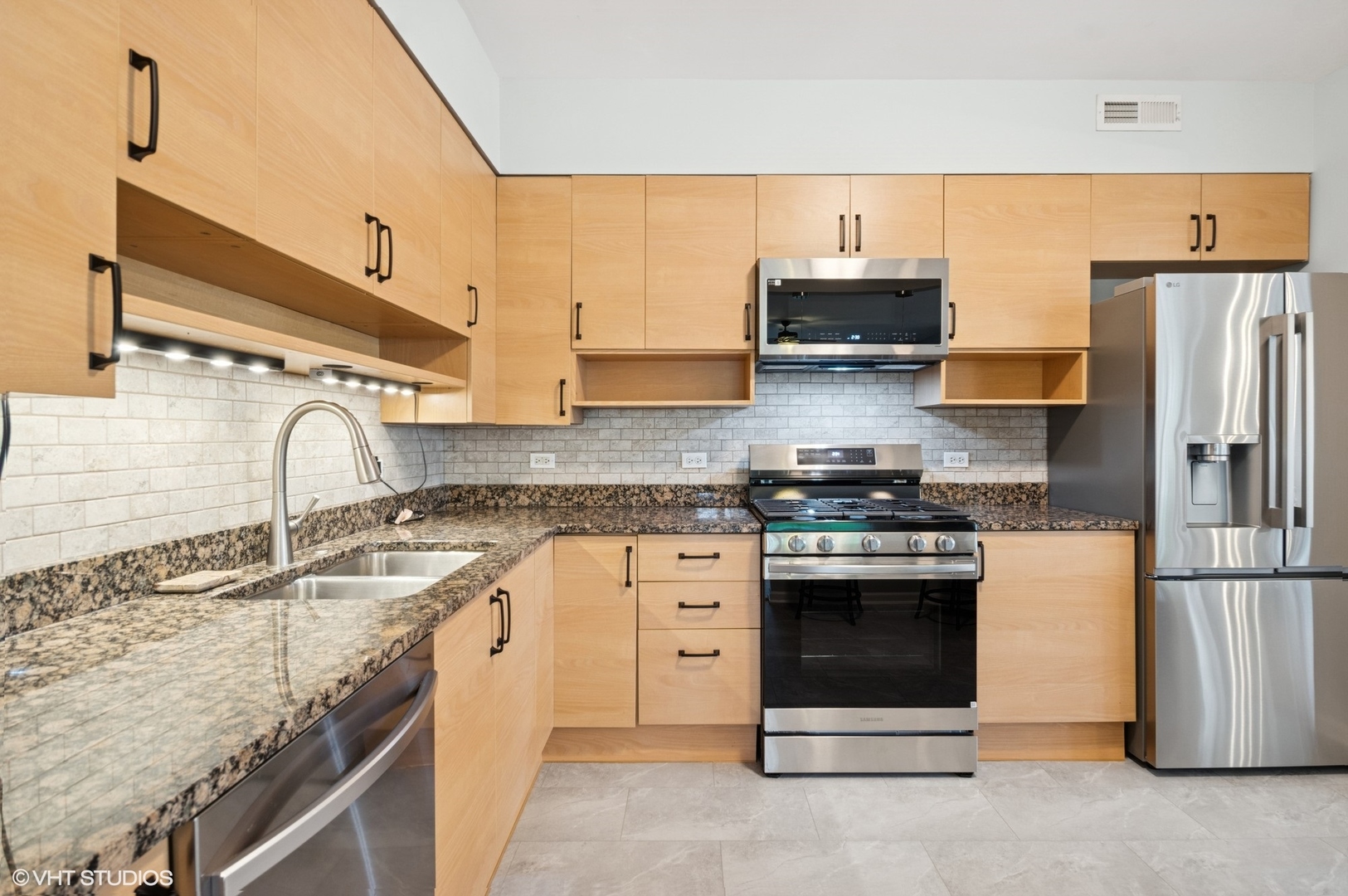 911 Busse Highway, Unit 302 Park Ridge, IL 60068 - Photo 6 of 17 a kitchen with stainless steel appliances granite countertop a sink stove and refrigerator