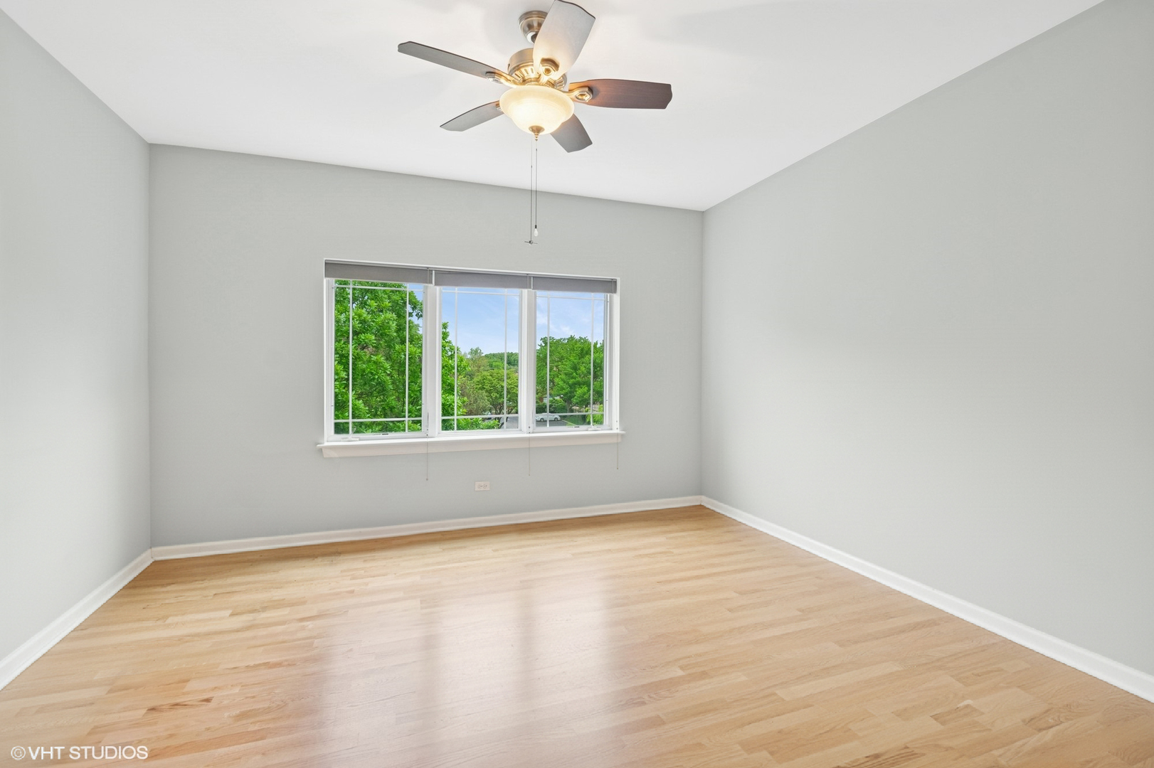 911 Busse Highway, Unit 302 Park Ridge, IL 60068 - Photo 8 of 17 an empty room with a window and a fan