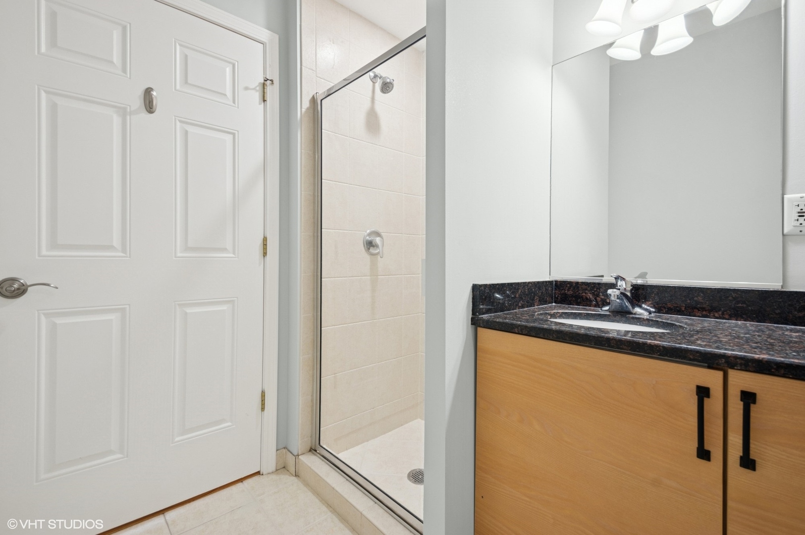 911 Busse Highway, Unit 302 Park Ridge, IL 60068 - Photo 10 of 17 a bathroom with a granite countertop sink a mirror and a shower