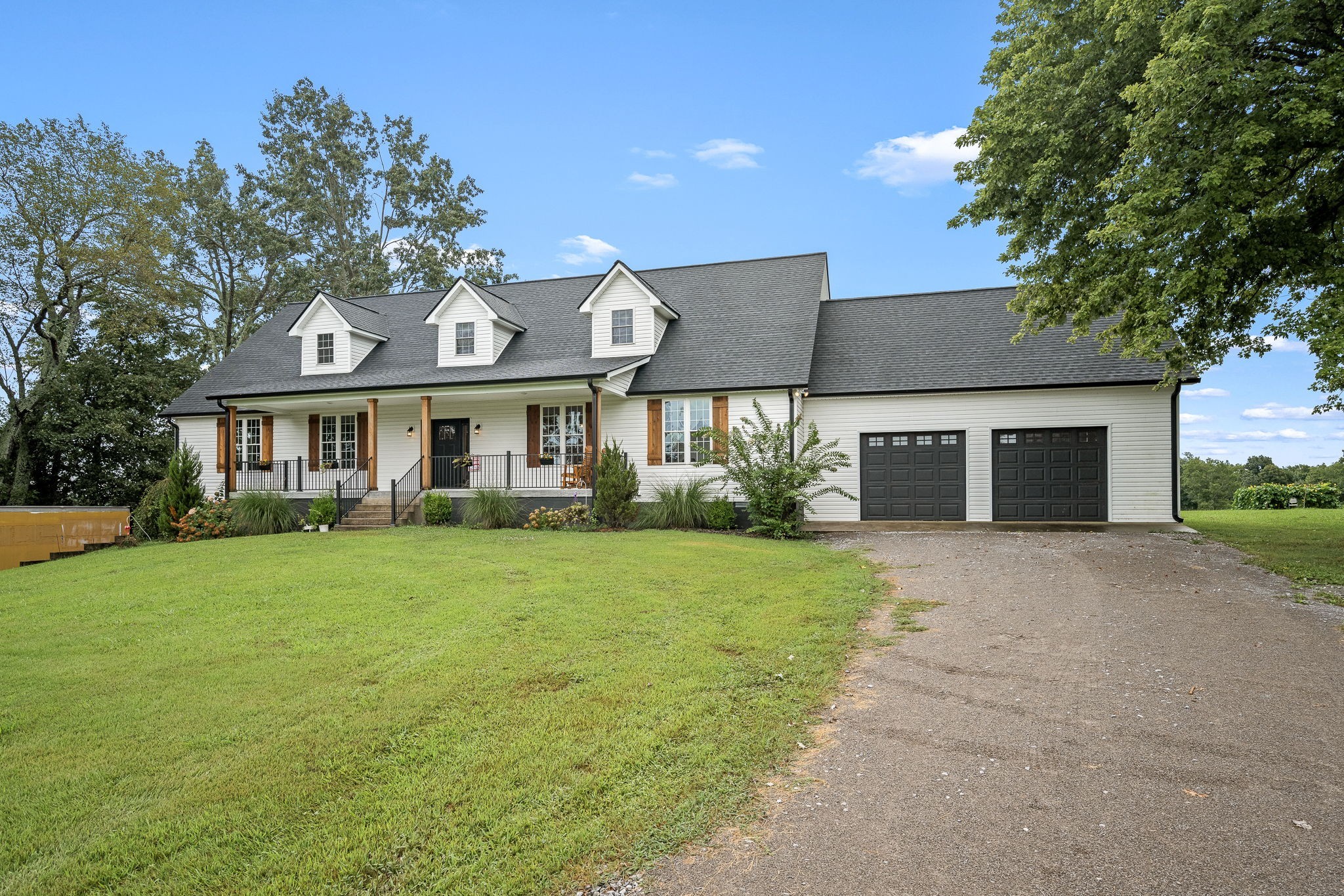 3880 Short Mountain Road Woodbury, TN 37190 - Photo 2 of 56 a front view of a house with a yard and garage