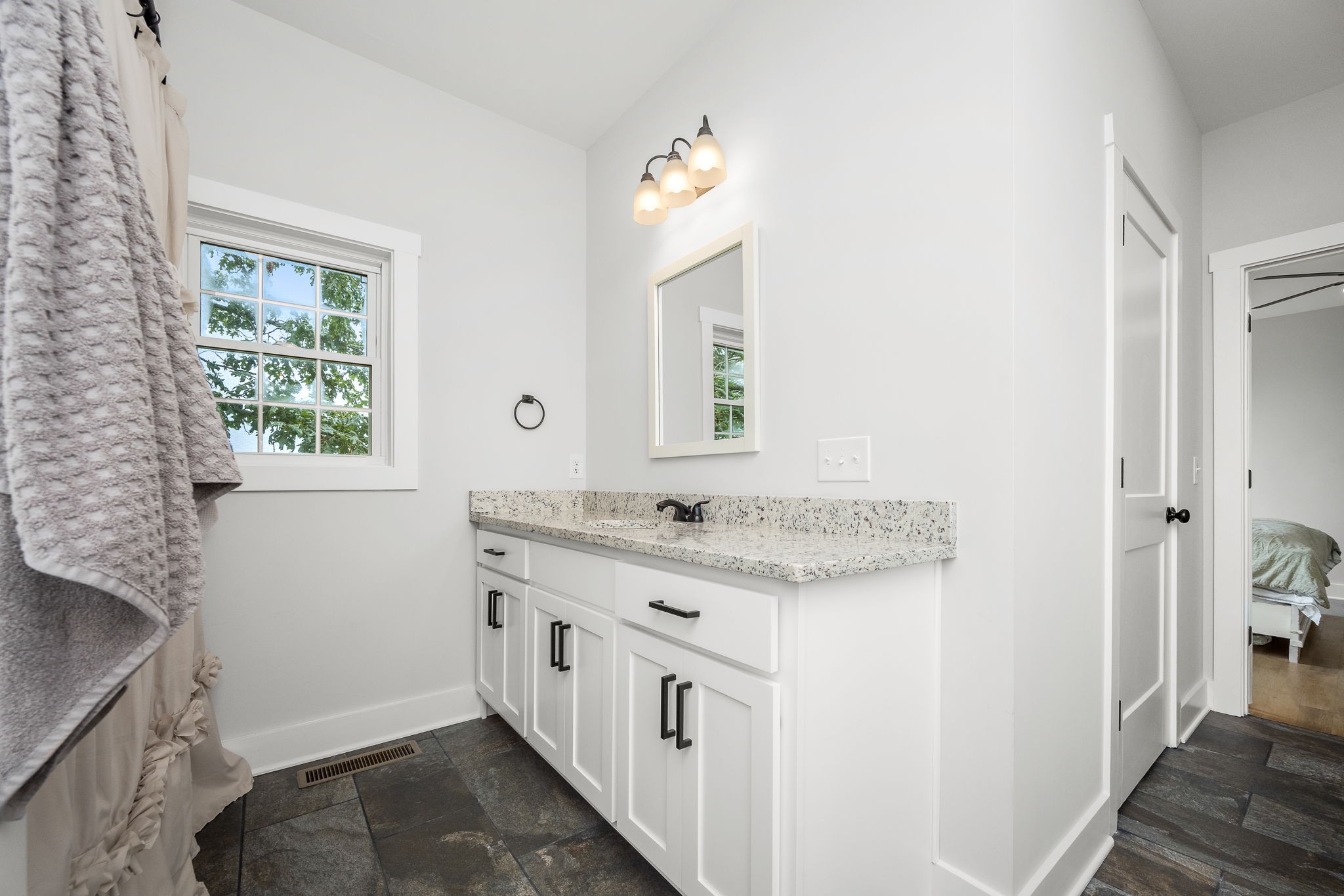 3880 Short Mountain Road Woodbury, TN 37190 - Photo 24 of 56 a bathroom with a granite countertop sink and a mirror