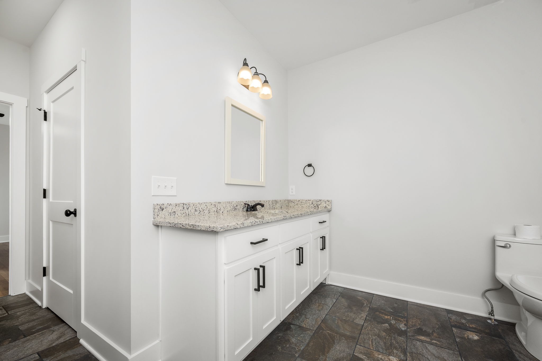 3880 Short Mountain Road Woodbury, TN 37190 - Photo 25 of 56 a bathroom with a granite countertop sink and a mirror