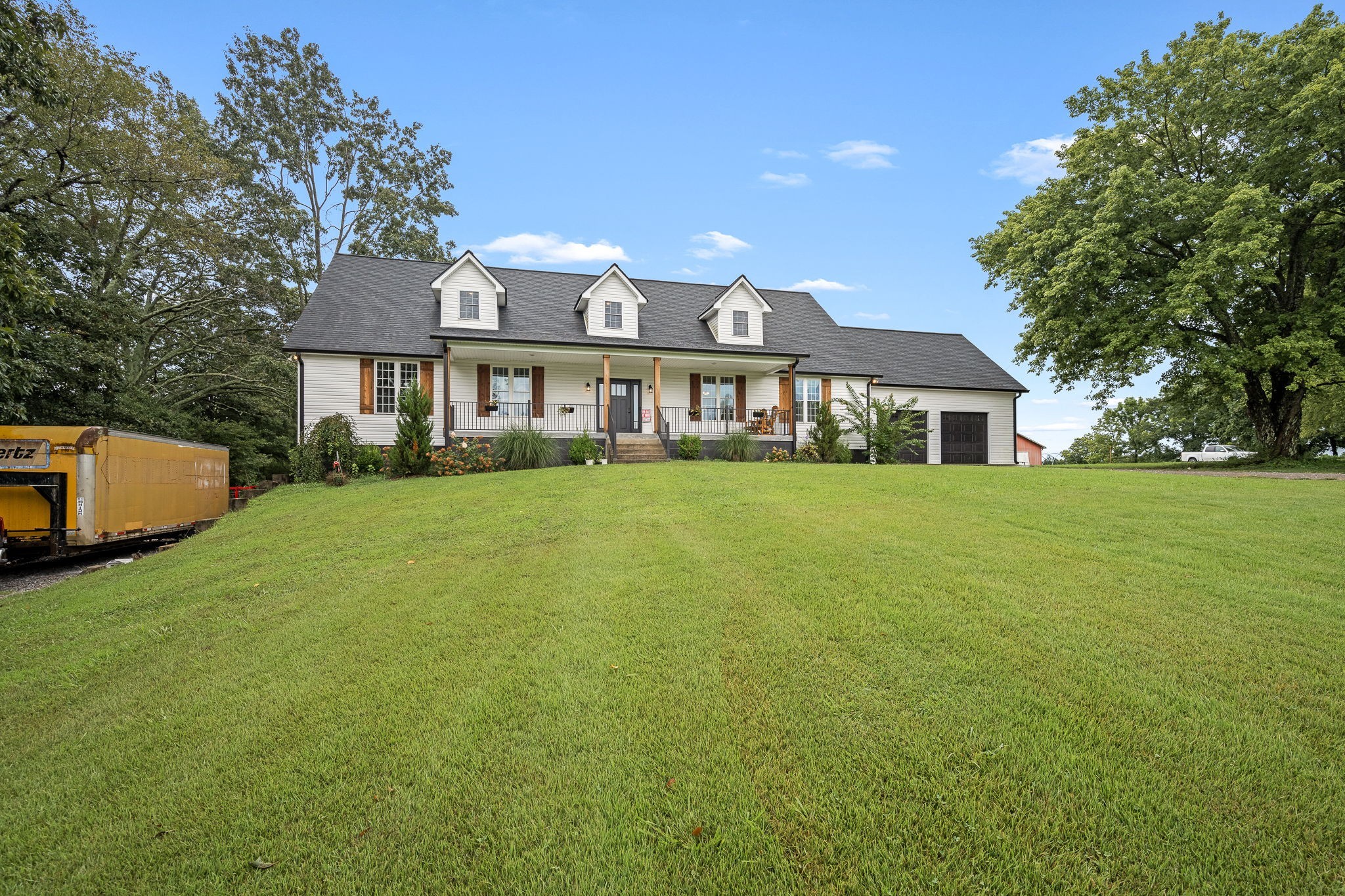 3880 Short Mountain Road Woodbury, TN 37190 - Photo 56 of 56 a view of a house next to a big yard and large trees