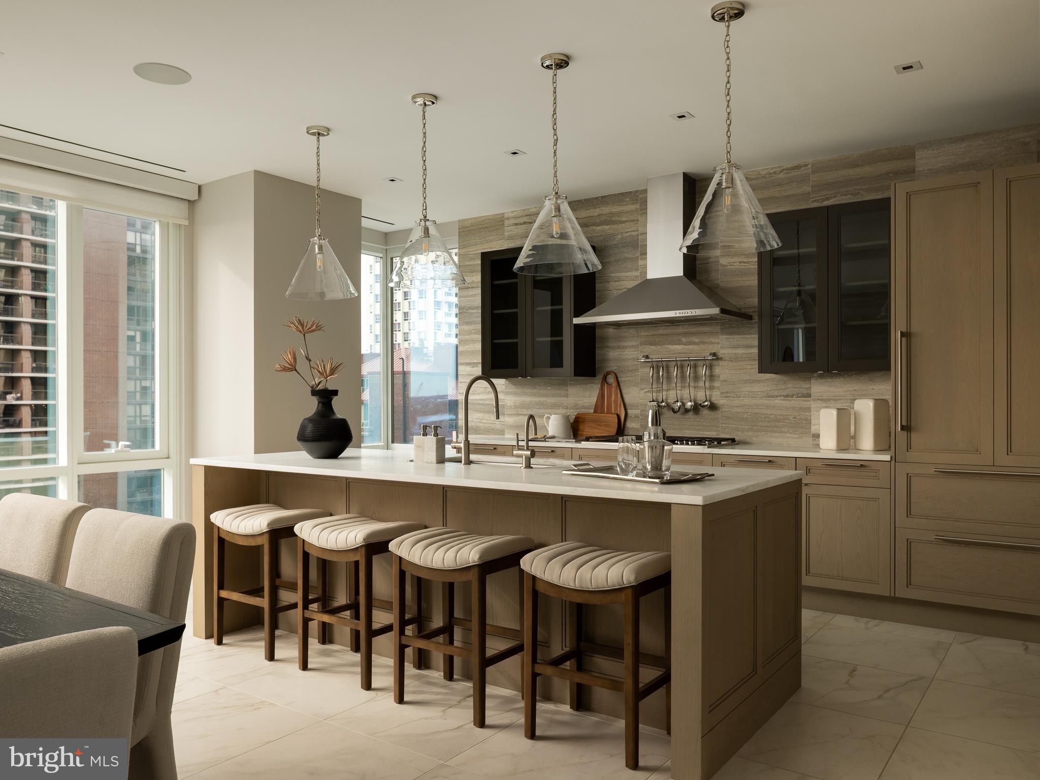500 Walnut Street, Unit 701 Philadelphia, PA 19106 - Photo 11 of 32 a kitchen with stainless steel appliances granite countertop a sink a stove and a wooden floor