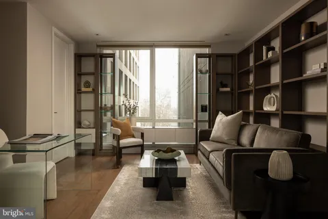 a living room with furniture fireplace and a large window