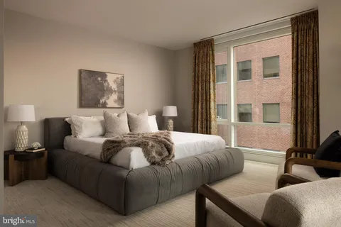 a bedroom with bed and a window