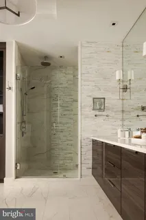 a bathroom with a shower and a sink