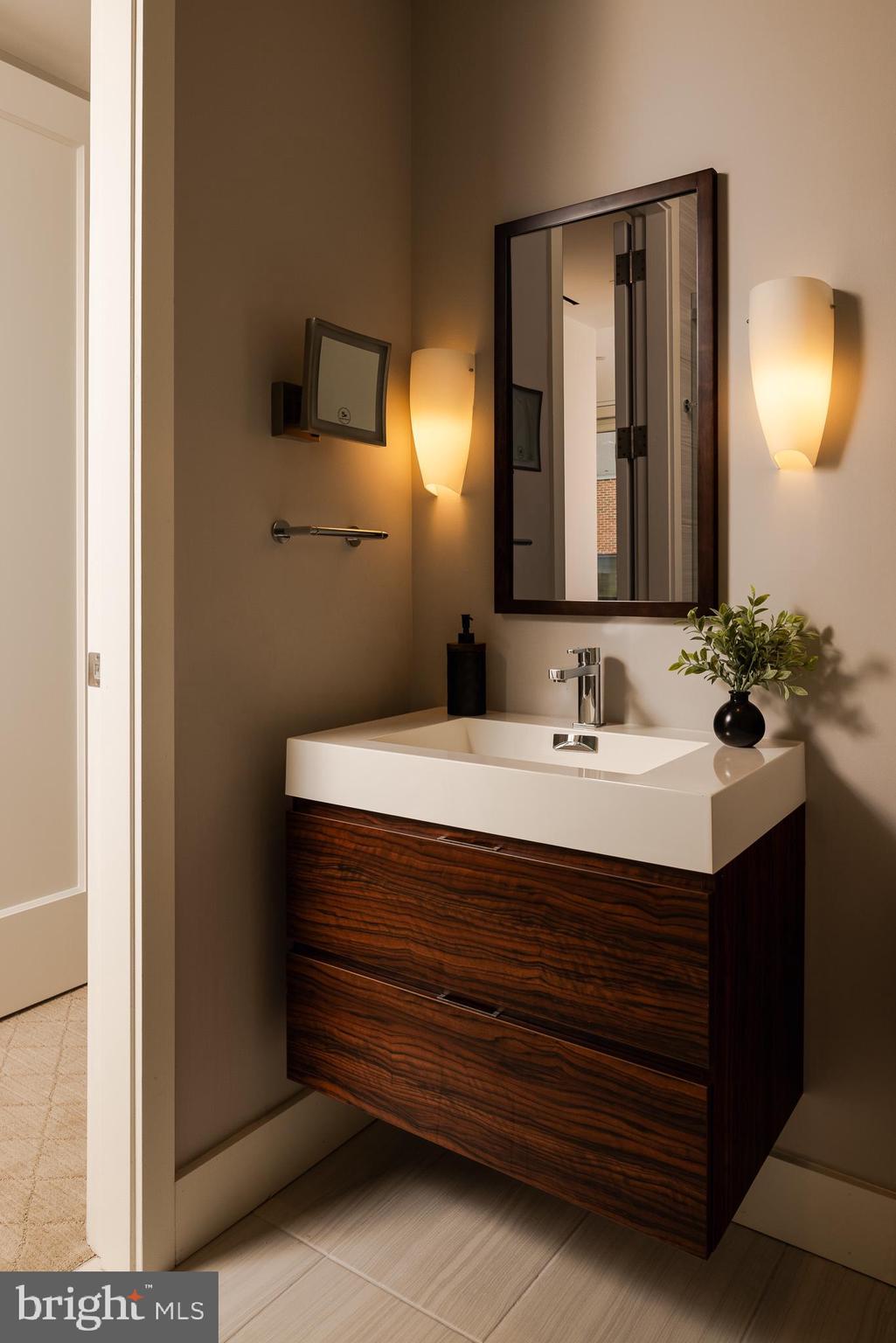 500 Walnut Street, Unit 701 Philadelphia, PA 19106 - Photo 24 of 32 a bathroom with a sink and a mirror