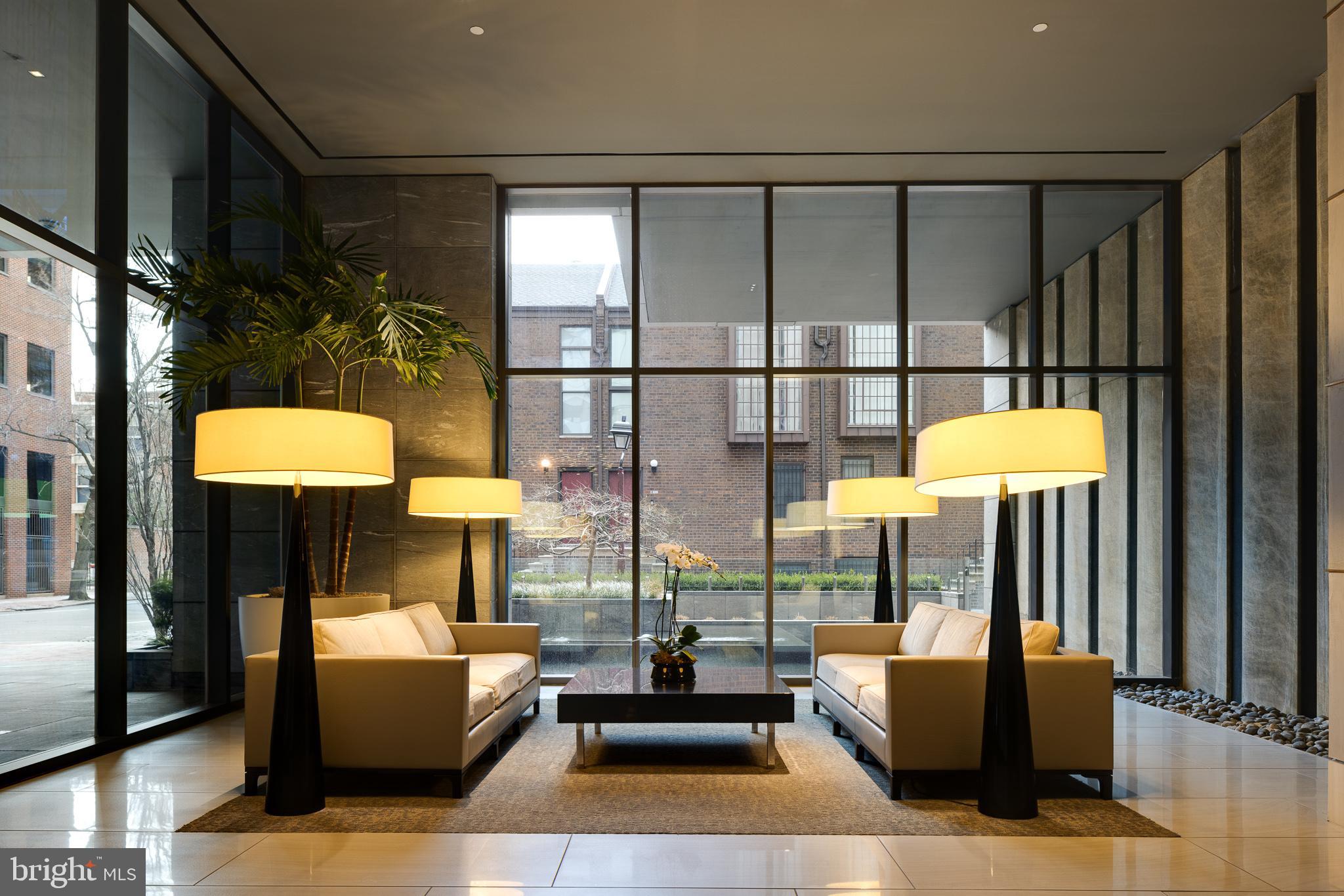 500 Walnut Street, Unit 701 Philadelphia, PA 19106 - Photo 29 of 32 a living room with fireplace furniture and a floor to ceiling window