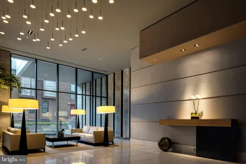 a living room with furniture a window and a chandelier
