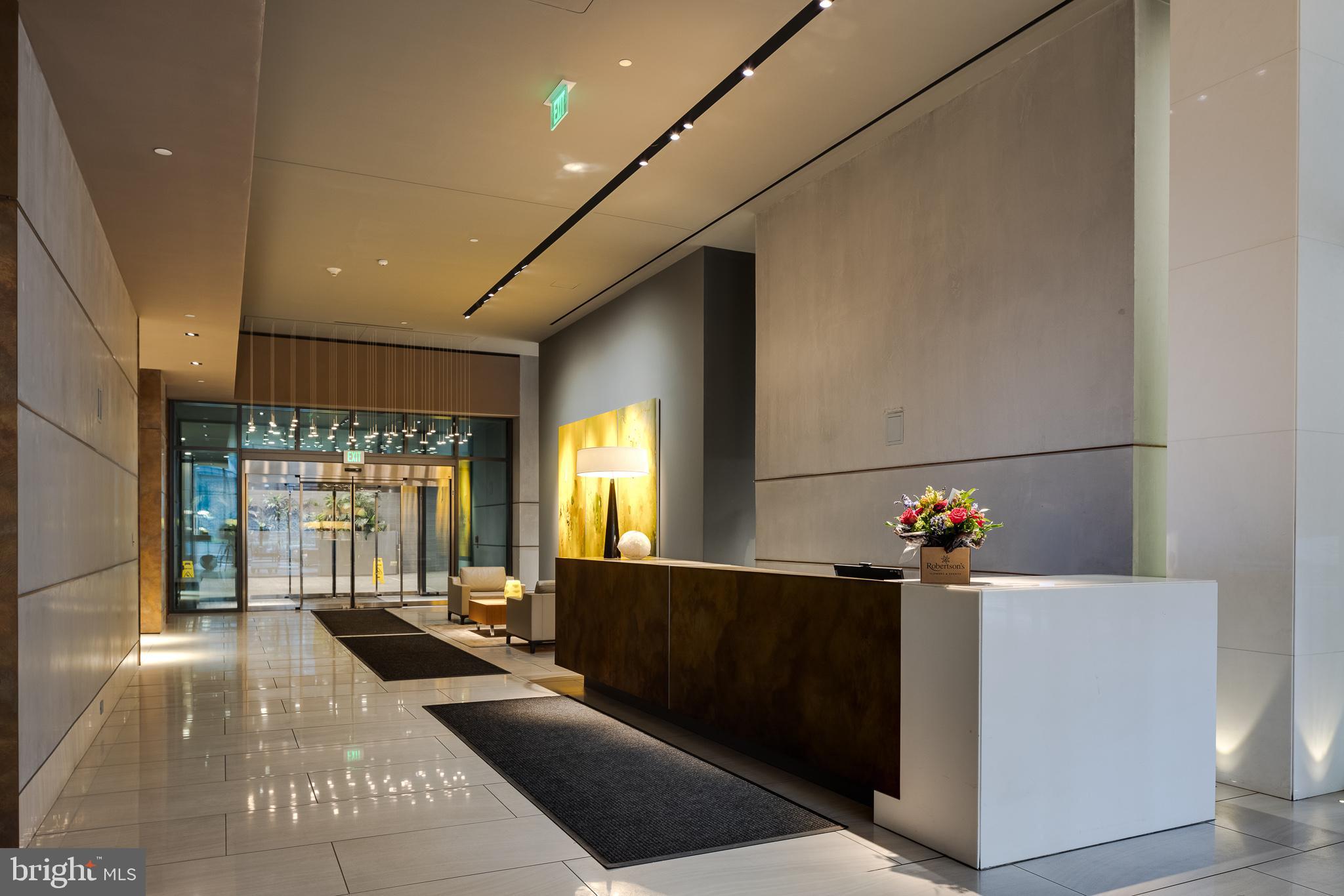 500 Walnut Street, Unit 701 Philadelphia, PA 19106 - Photo 31 of 32 a living room with furniture a window and a chandelier