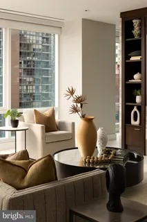 a living room with furniture a rug and a window