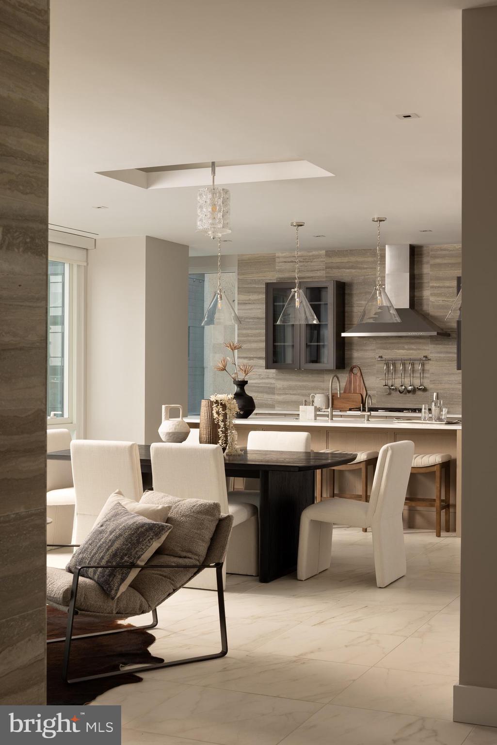 500 Walnut Street, Unit 701 Philadelphia, PA 19106 - Photo 7 of 32 a living room with furniture a flat screen tv and kitchen view