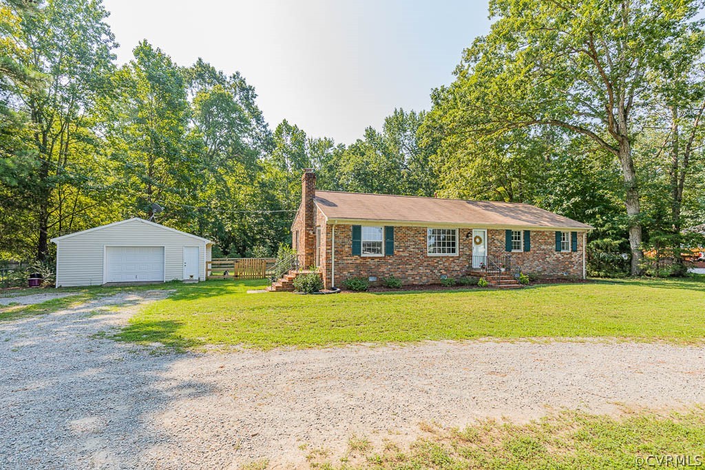 7421 River Road Hanover, VA 23069 - Photo 1 of 23 a front view of a house with a garden and trees