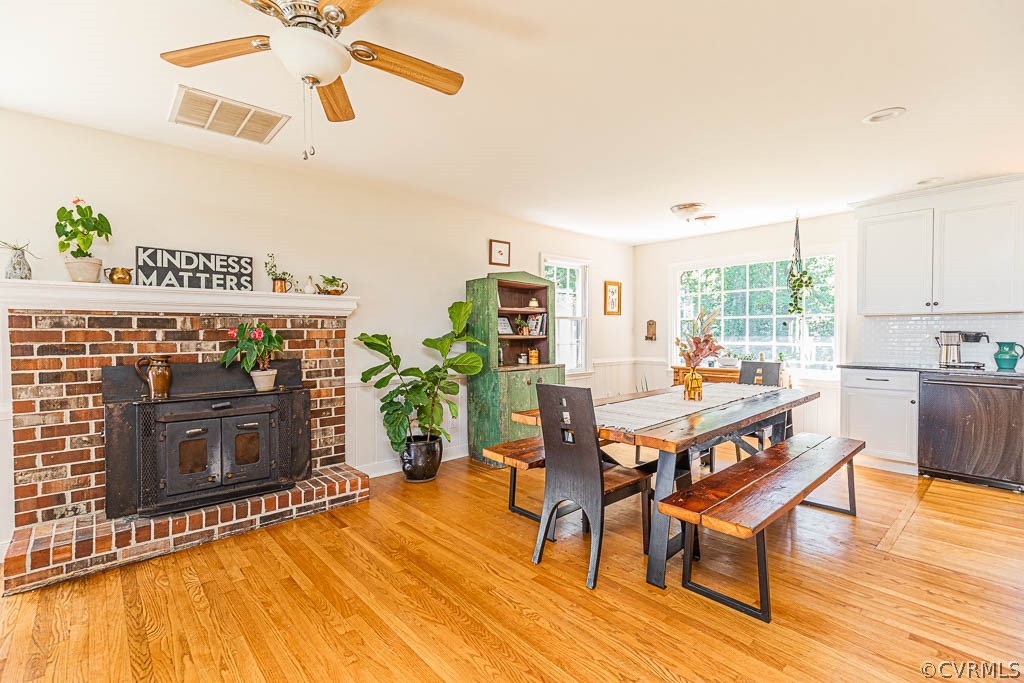 7421 River Road Hanover, VA 23069 - Photo 8 of 23 a dining room with furniture a fireplace and wooden floor