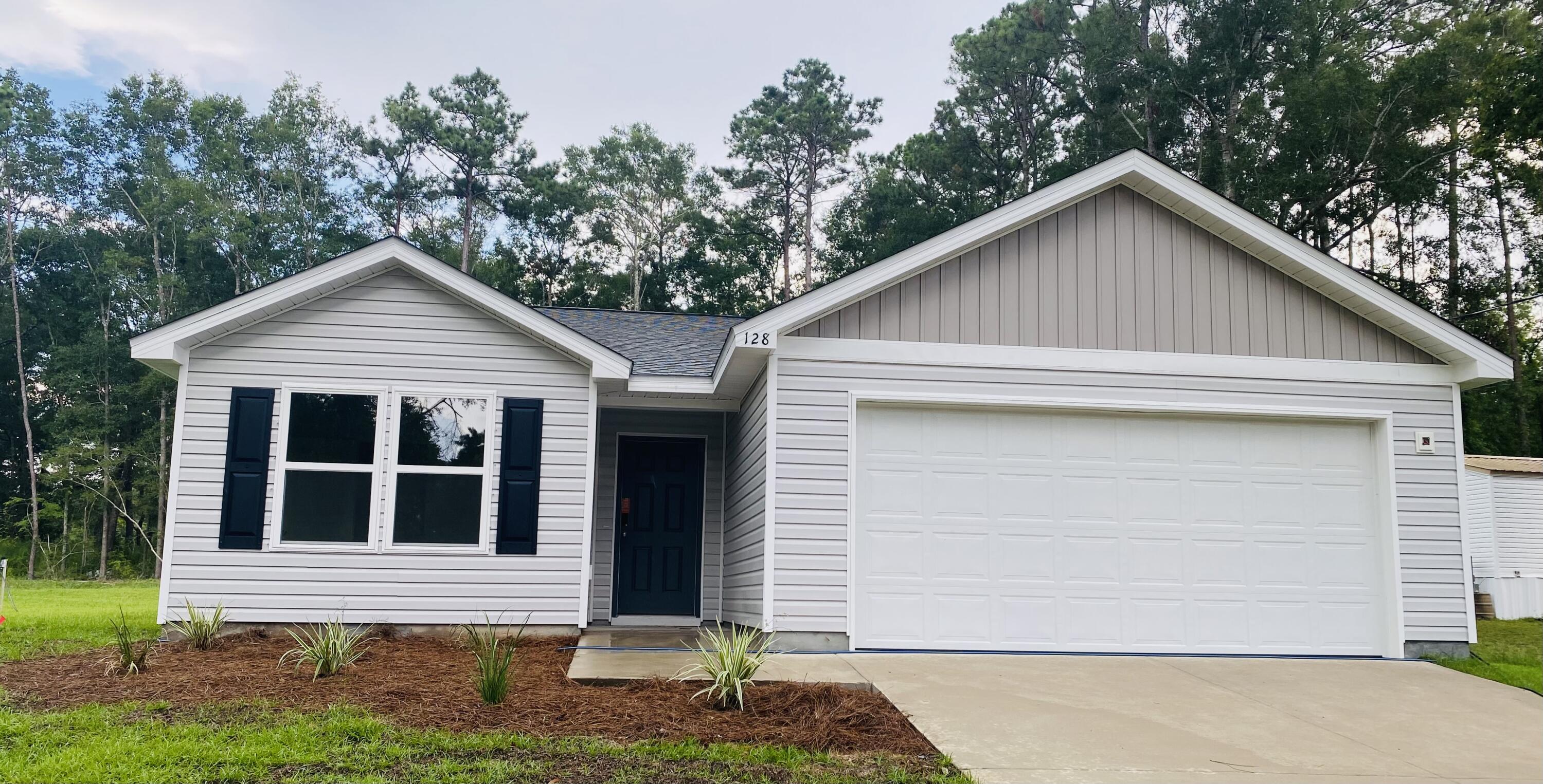 128 Squirrel Road DeFuniak Springs, FL 32433 - Photo 1 of 12 a front view of a house with a yard