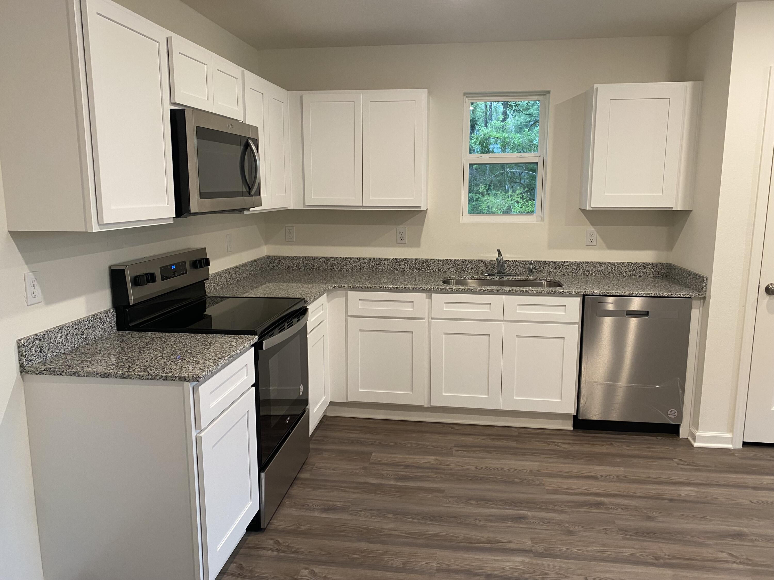 128 Squirrel Road DeFuniak Springs, FL 32433 - Photo 2 of 12 a kitchen with a sink stove top oven and cabinets