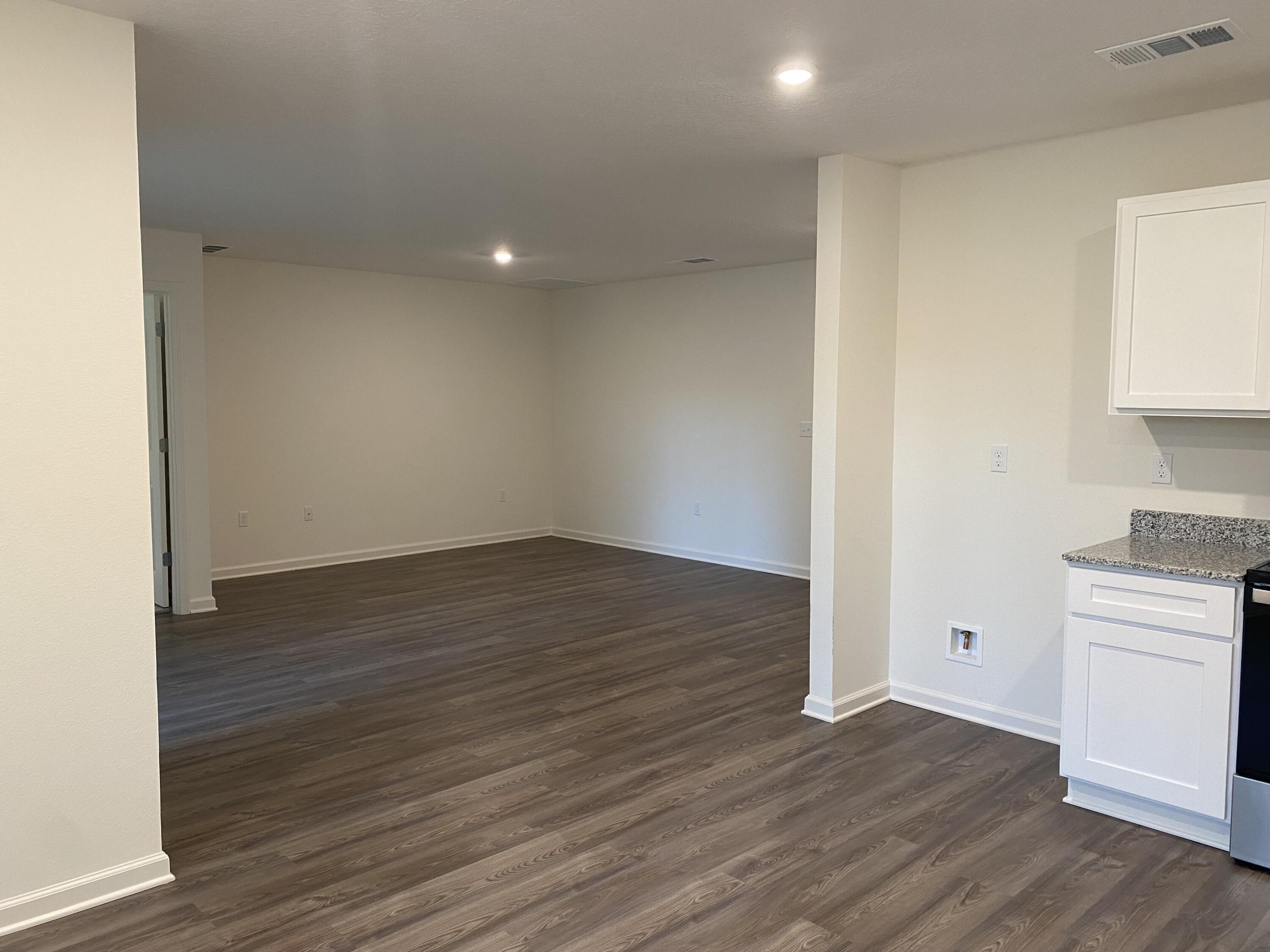 128 Squirrel Road DeFuniak Springs, FL 32433 - Photo 3 of 12 a view of a room with wooden floor and white doors