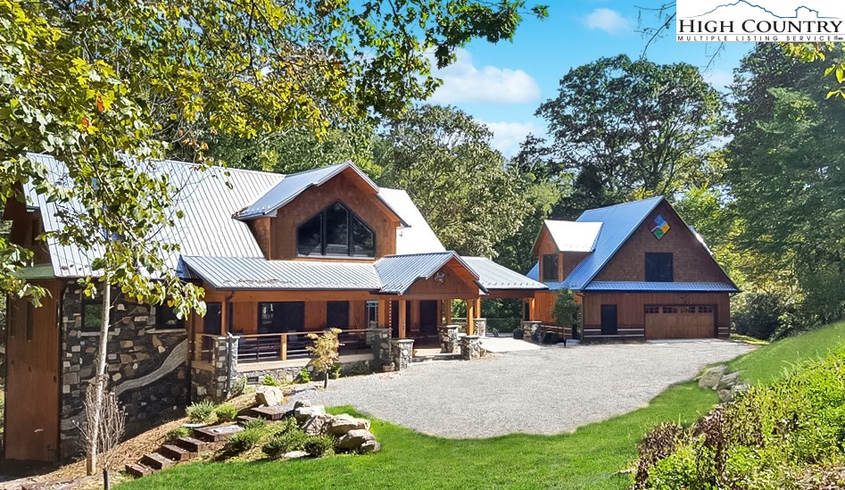 a front view of house with yard and trees in the background