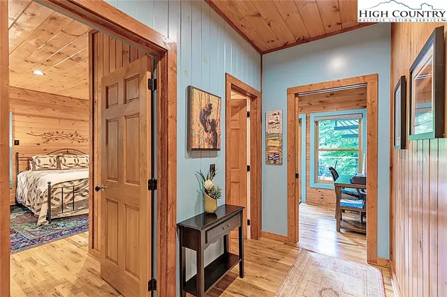 a view of a hallway with bathroom and glass door