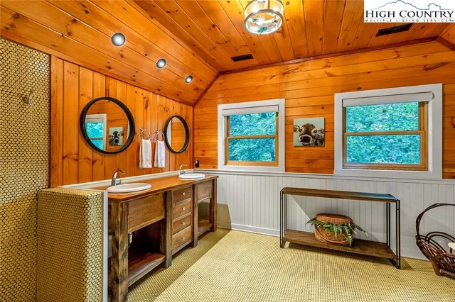 a bathroom with a sink a mirror and a window