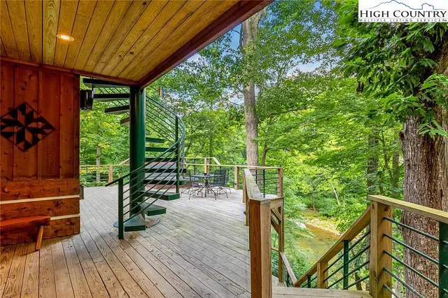 a view of deck with furniture and garden