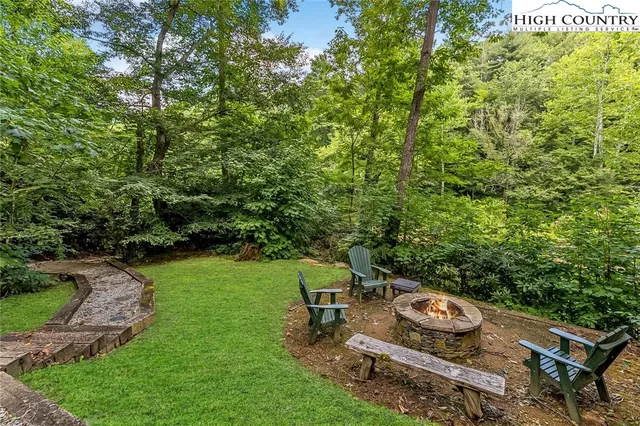 a view of a backyard with table and chairs and potted plants