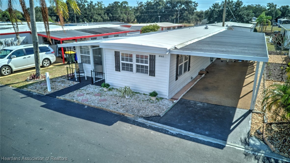 8065 Von Maxcy Road Sebring, FL 33870 - Photo 3 of 37 Long covered carport with side entrance and shed.