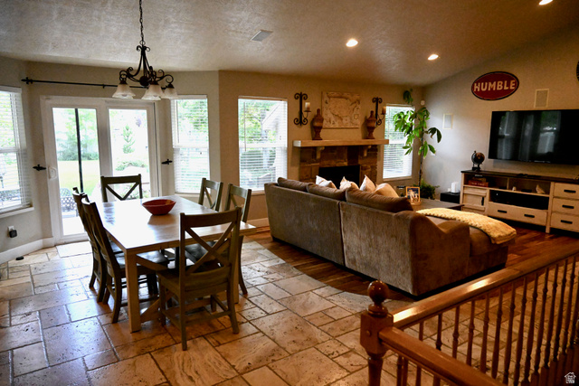 314 Brown Farm Lane Draper, UT 84020 - Photo 10 of 57 Open concept living space featuring a stone fireplace with a substantial mantel, recessed lighting, and a blend of wood-finish and stone tile flooring