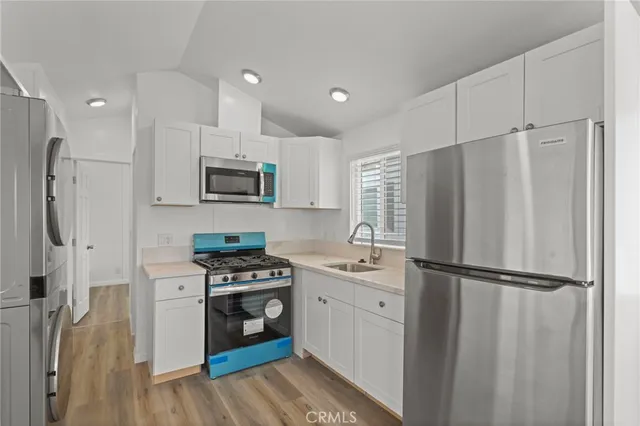 a kitchen with stainless steel appliances a refrigerator stove and microwave