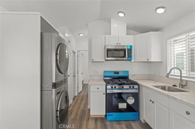 a kitchen with a sink a stove and cabinets