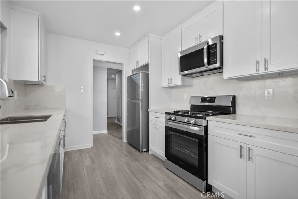 1791 Sitka Avenue Simi Valley, CA 93063 - Photo 22 of 44 a kitchen with stainless steel appliances granite countertop a stove a sink and a refrigerator