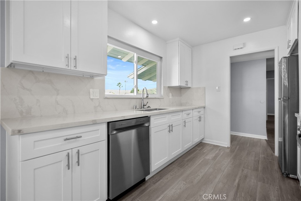 1791 Sitka Avenue Simi Valley, CA 93063 - Photo 24 of 44 a kitchen with white cabinets appliances and a sink