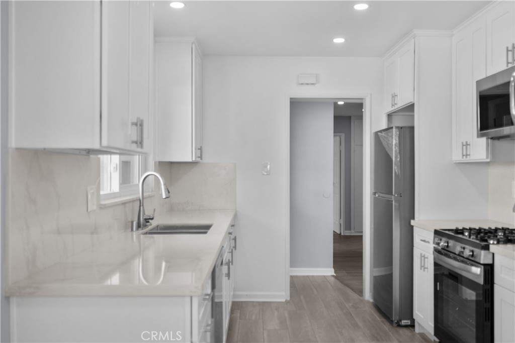 1791 Sitka Avenue Simi Valley, CA 93063 - Photo 25 of 44 a kitchen with stainless steel appliances granite countertop a refrigerator and a sink