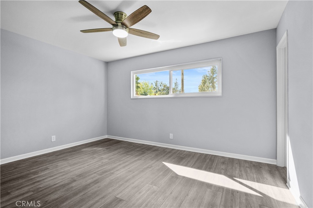1791 Sitka Avenue Simi Valley, CA 93063 - Photo 32 of 44 an empty room with wooden floor and ceiling fan