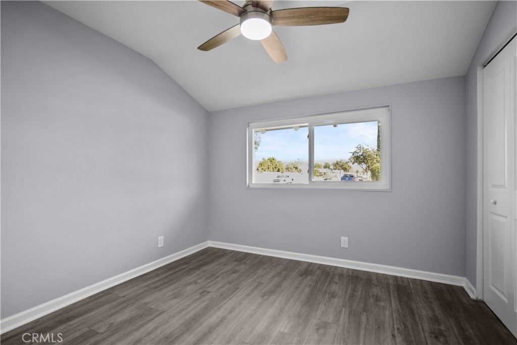 1791 Sitka Avenue Simi Valley, CA 93063 - Photo 33 of 44 an empty room with wooden floor chandelier fan and windows