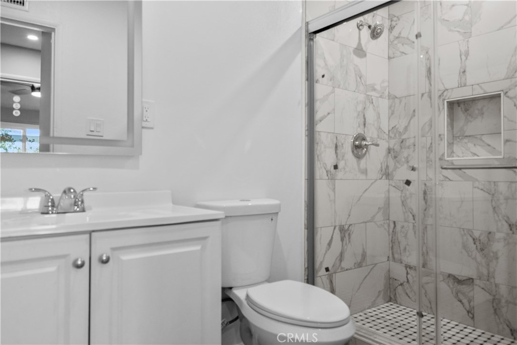 1791 Sitka Avenue Simi Valley, CA 93063 - Photo 36 of 44 a bathroom with a granite countertop sink toilet and shower