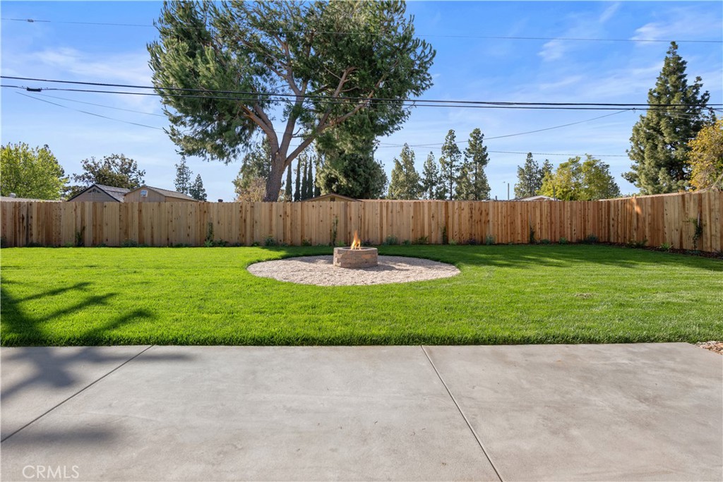 1791 Sitka Avenue Simi Valley, CA 93063 - Photo 4 of 44 a view of a backyard with a large tree and wooden fence