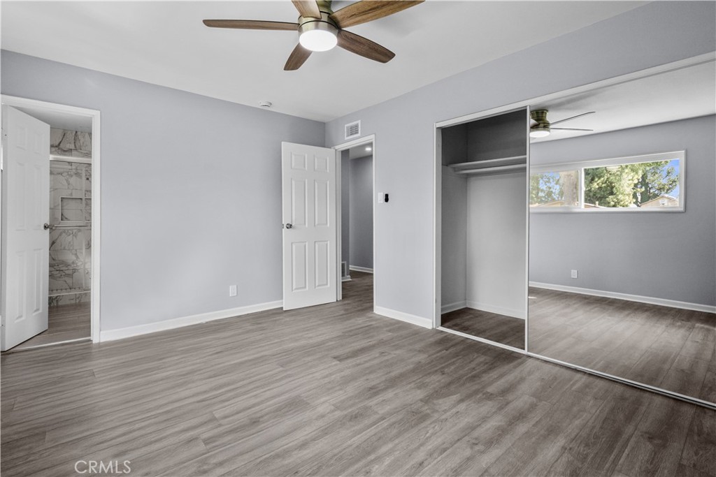 1791 Sitka Avenue Simi Valley, CA 93063 - Photo 43 of 44 a view of an empty room with wooden floor and a ceiling fan