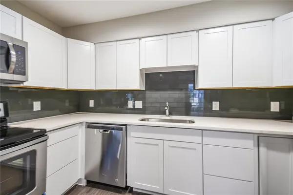 a kitchen with a sink and cabinets