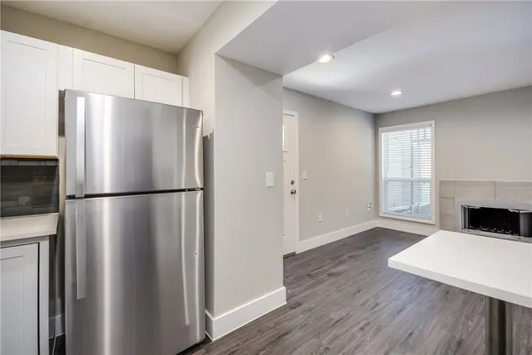 a kitchen with a refrigerator a stove top oven a refrigerator and a window