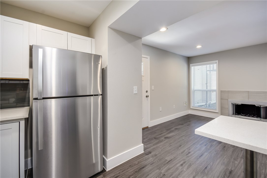935 La Posada Drive, Unit 142 Austin, TX 78752 - Photo 14 of 28 a kitchen with a refrigerator a stove top oven a refrigerator and a window