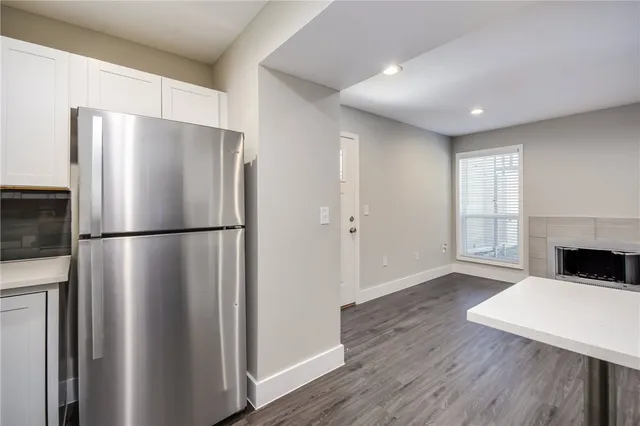 a kitchen with a refrigerator a stove top oven a refrigerator and a window