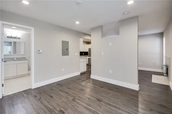 wooden floor in an empty room with a kitchen