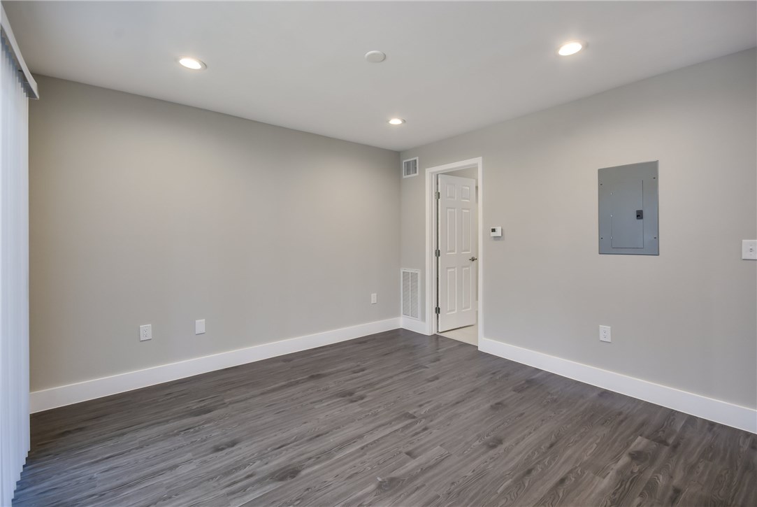 935 La Posada Drive, Unit 142 Austin, TX 78752 - Photo 18 of 28 a view of an empty room with wooden floor