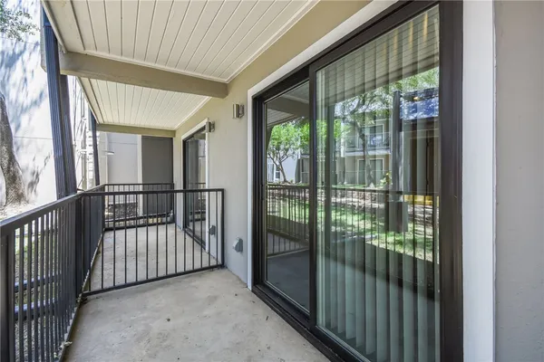 a view of a porch with wooden floor