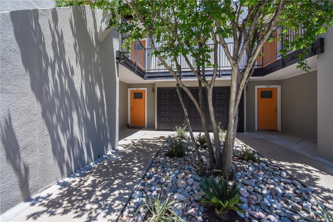 935 La Posada Drive, Unit 142 Austin, TX 78752 - Photo 28 of 28 a view of a house with a large tree and wooden fence